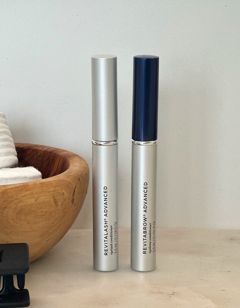 Two Revitalash Advanced eye care products on a neutral background